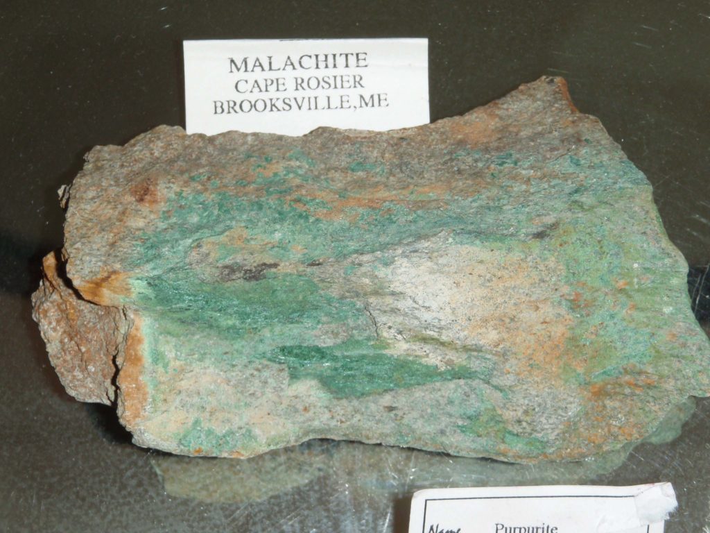 Malachite is green, and so this rock has much blue-green malachite in it.