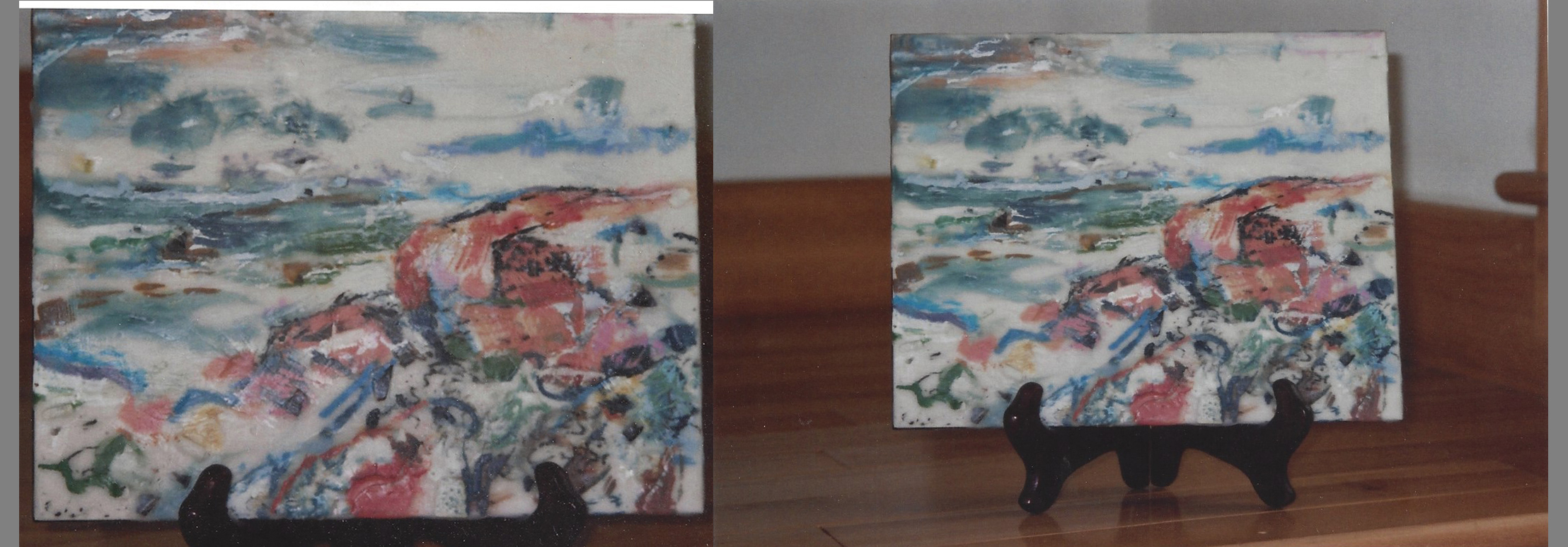 an encaustic painting in many vibrant colors, with a rose colored boulder at the edge of the ocean bay